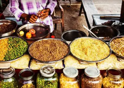 An outdoor Indian market showcasing a variety of spices.