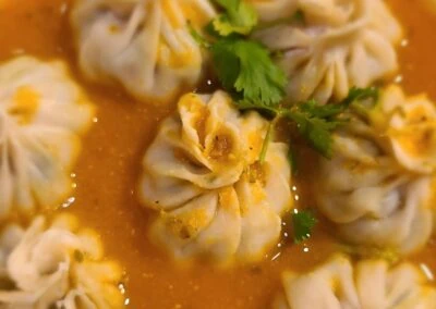 Tibetan momos in a rich sauce