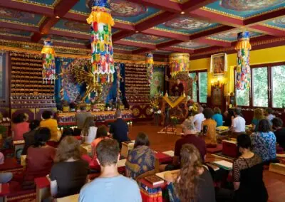 At the Kalapa Meditation Retreat Center, Khentrul Rinpoche delivers a Dharma teaching before the grand 24-armed Kalachakra statue